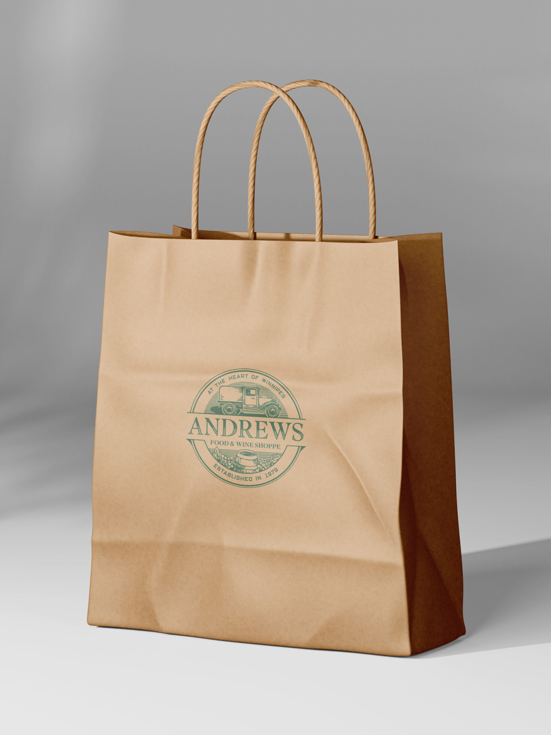 Brown paper bag with Andrews green logo stamped upon